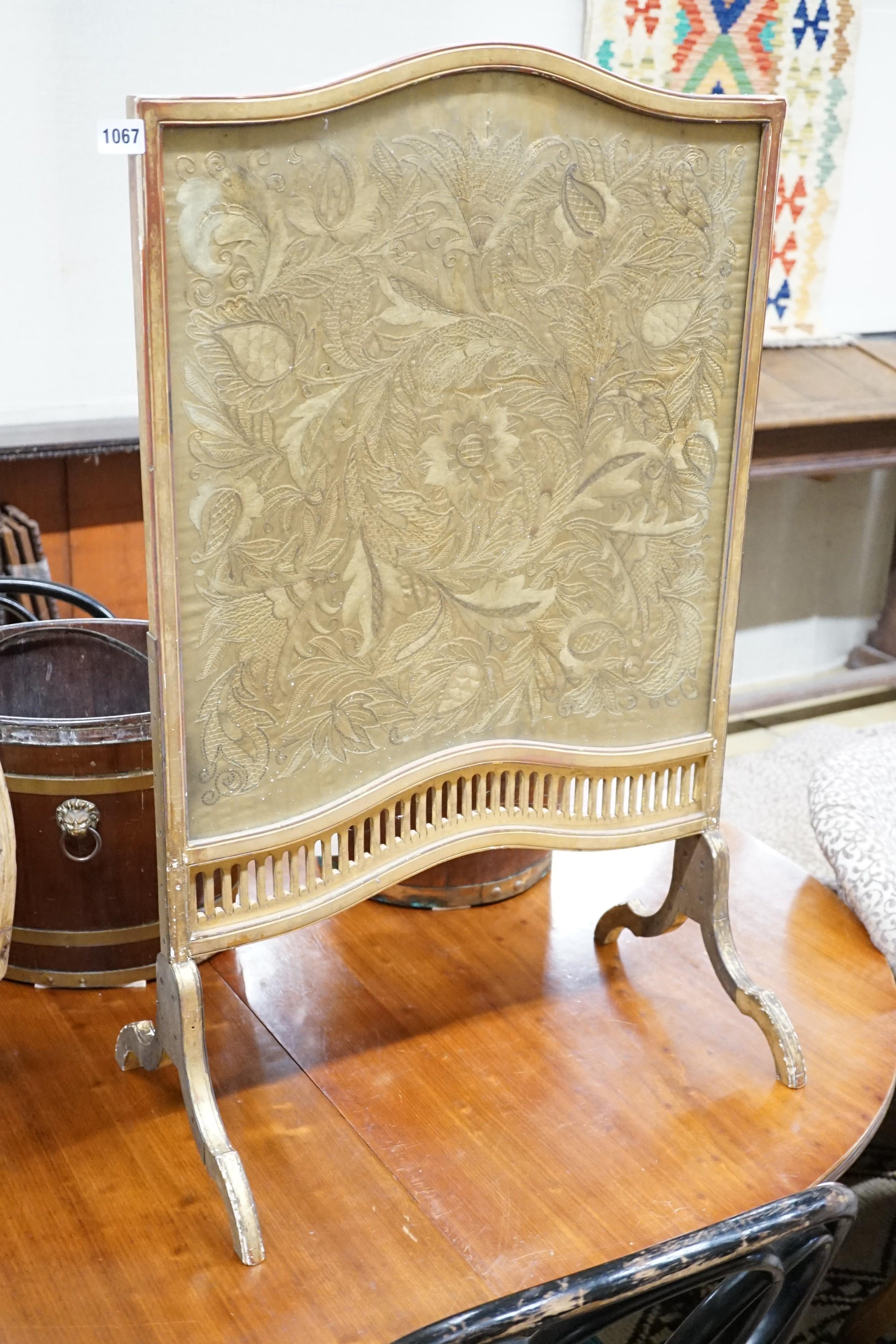 A carved gilt wood fire screen with internal needlework panel, width 56cm, height 92cm